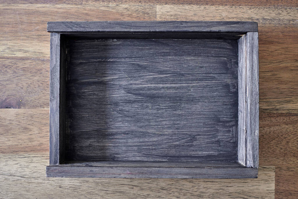 A studio photo of a black wooden box - Fotó, kép