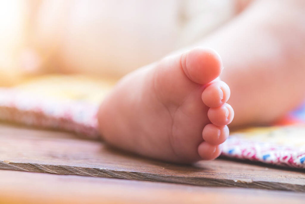Close up of newborn baby feet, outdoors on baby blanket - Photo, Image