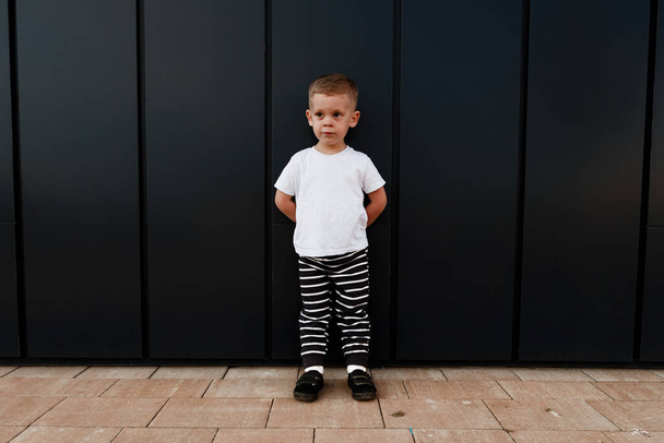 little boy in white t-shirt. space for your logo or design. Mockup for print - Foto, afbeelding