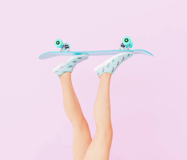female legs with skateboard on pastel color background. vintage style. 3d render - Foto, Imagen