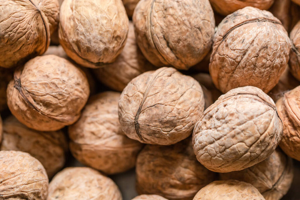 Ripe whole walnuts in their shells, top view close-up in selective focus - Photo, Image