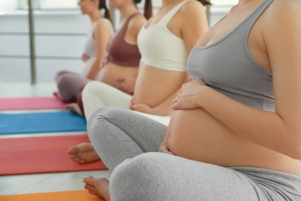 Group of pregnant women in gym, closeup. Preparation for child birth - Foto, imagen