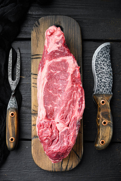 Rib eye beef meat cut raw set, on black wooden table background, top view flat lay - Fotoğraf, Görsel
