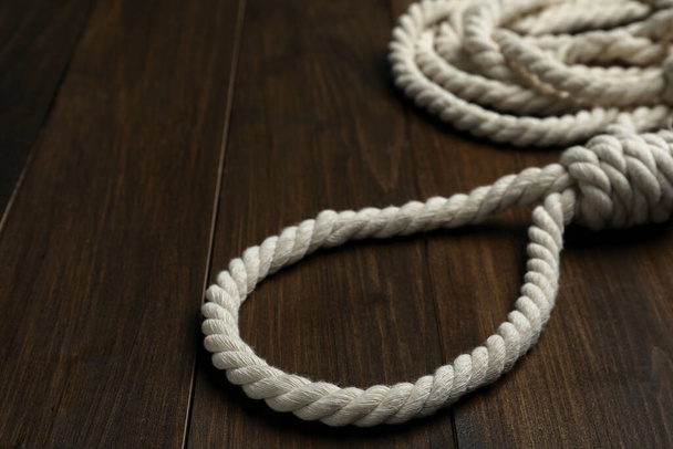 Rope noose on wooden table, closeup view - 写真・画像