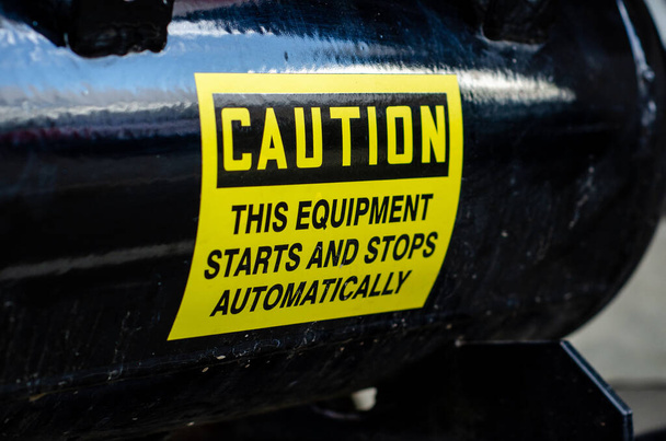 Caution Safety Sign: This Equipment Starts And Stops Automatically - Photo, Image