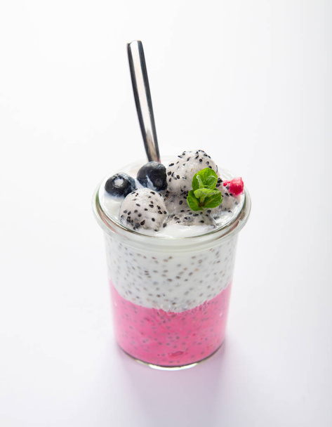 Layered chia puding with pink filling on white background. Healthy breakfast concept. - Photo, Image