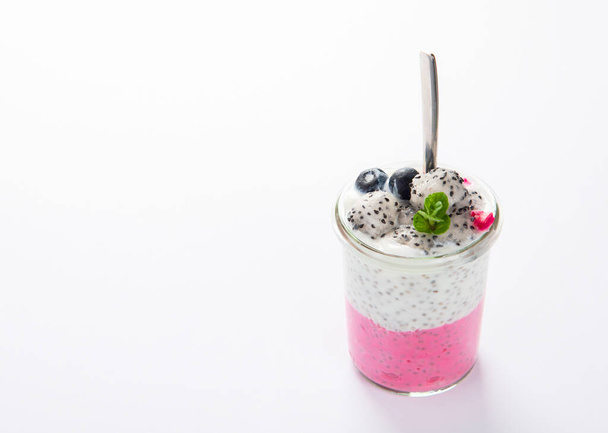 Layered chia puding with pink filling on white background. Healthy breakfast concept. - Photo, Image