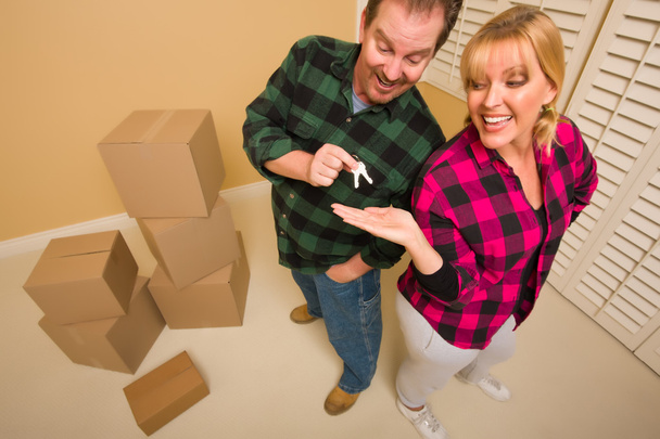 Goofy Excited Man Handing Keys to Smiling Wife - Photo, Image