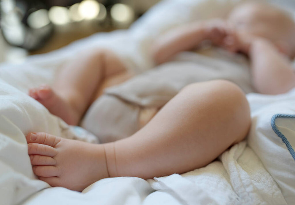 close-up of 3 month old baby sleeping in bodysuit - Foto, immagini
