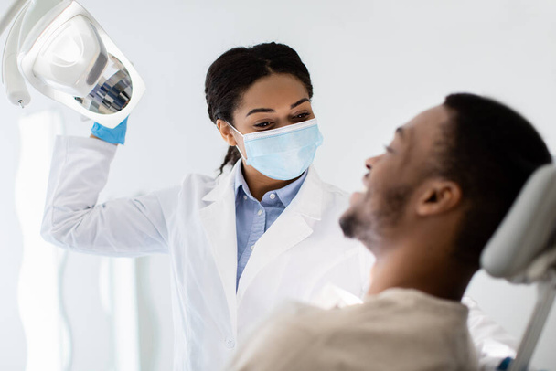 Dentistry Concept. Young Black Patient Guy Having Check Up With Dentist Woman - Фото, изображение