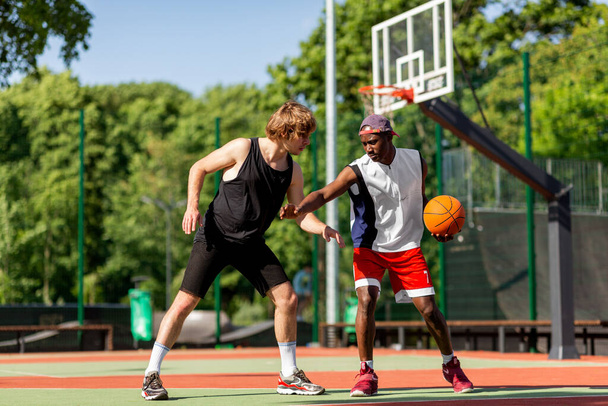 Two professional basketball players training for competition at outdoor court - Fotó, kép