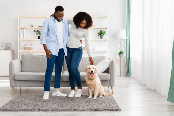 Black couple spending time at home with dog - Zdjęcie, obraz