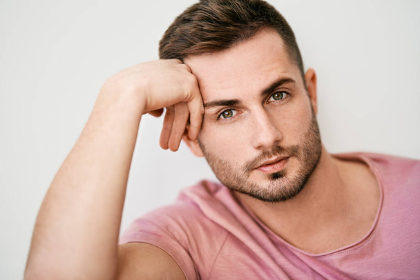 Closeup portrait of handsome sexy man looking at camera on white background - 写真・画像