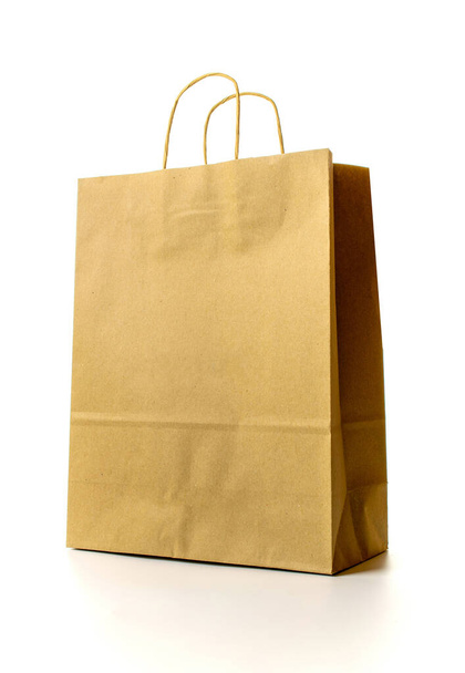 Brown paper bag texture. Kraft recycle package with empty blank space for design mockup isolated on white background. Delivery service concept. Copy space. Advertising area - Foto, afbeelding