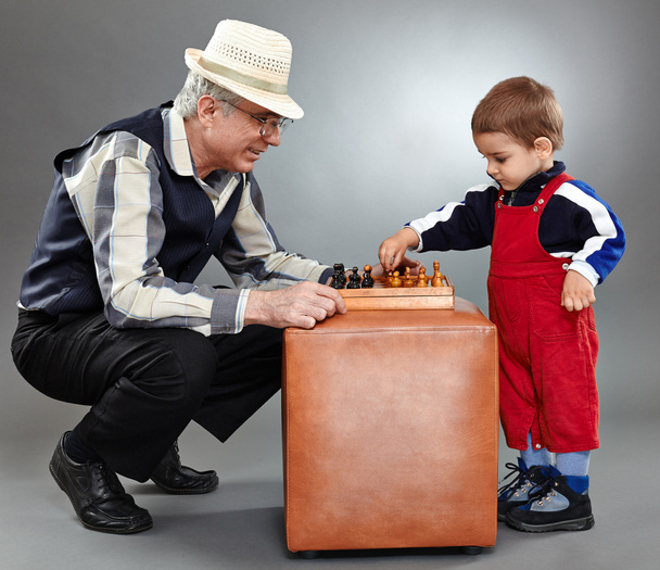 Grandfather and grandson playing chess - Valokuva, kuva