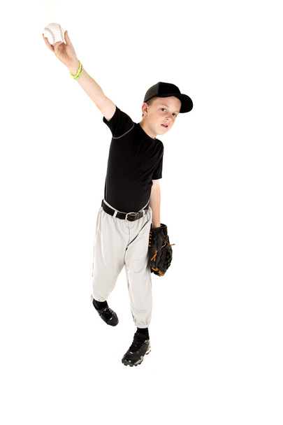 young boy in uniform pitching a baseball right handed - Foto, Imagen