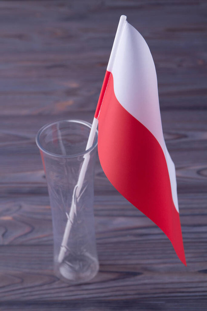 Vertical shot red and white flag of Poland in the glass vase. - Foto, imagen