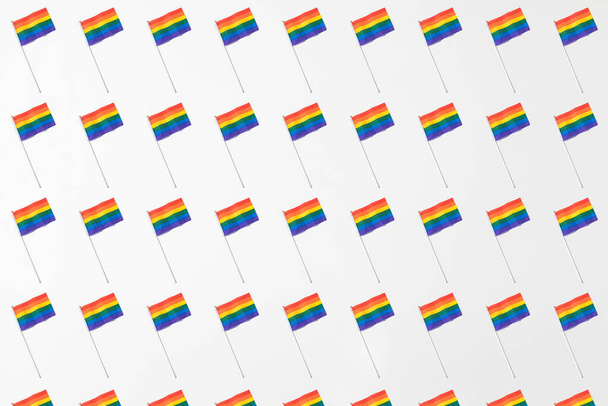 Lgtbi community rainbow flags pattern with hard shadow on white background. Pride day concept - Photo, Image