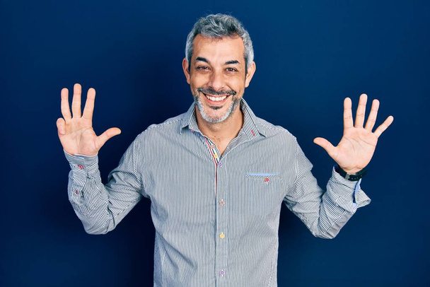 Handsome middle age man with grey hair wearing business shirt showing and pointing up with fingers number nine while smiling confident and happy.  - Photo, Image
