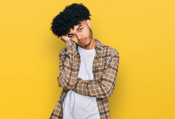Young african american man with afro hair wearing casual clothes thinking looking tired and bored with depression problems with crossed arms.  - Photo, Image