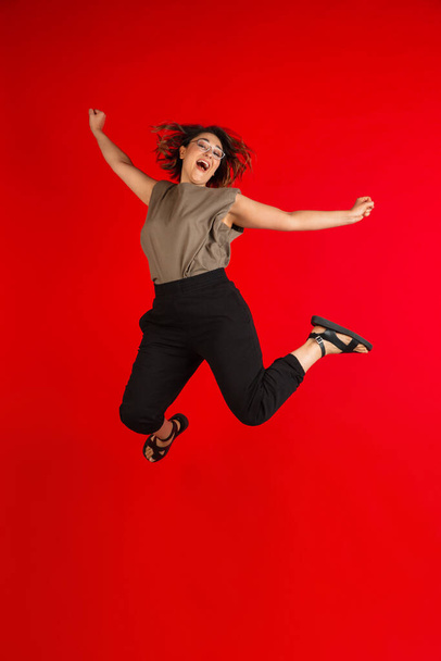 One young Caucasian beautiful woman in casual style isolated on bright red background. - 写真・画像