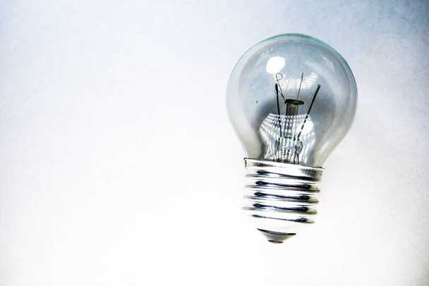 Non-working incandescent light bulb on a white background - Photo, image