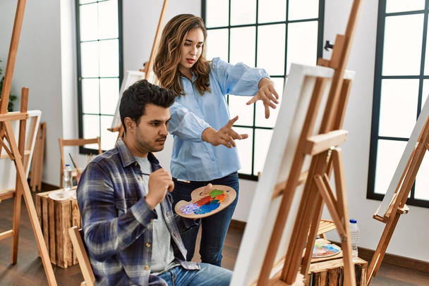 Paint teacher teaching to student at art school. - Foto, Imagen
