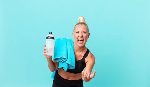 pretty blond woman looking angry, annoyed and frustrated. fitness concept - Zdjęcie, obraz