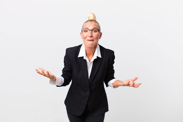pretty blond woman feeling extremely shocked and surprised. business concept - Foto, Imagen