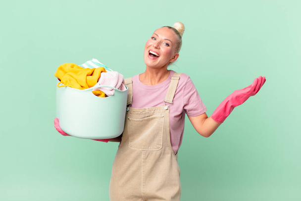 pretty blond woman feeling happy and astonished at something unbelievable washing clothes concept - Photo, Image