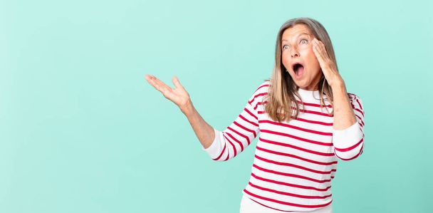 pretty middle age woman feeling happy, excited and surprised - Фото, изображение