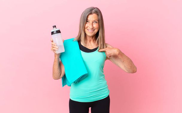 pretty middle age woman feeling happy and pointing to self with an excited. fitness concept - Foto, immagini
