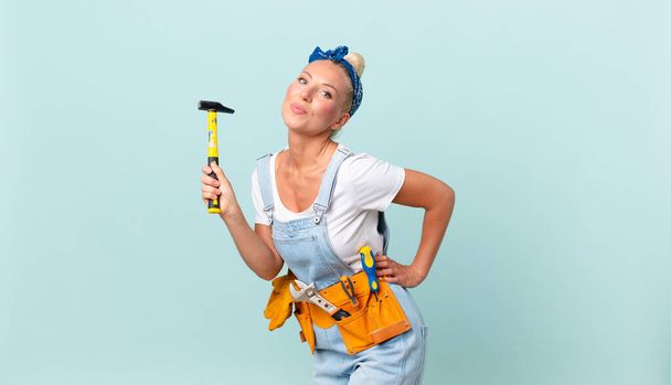 adult pretty woman with a hammer. repair concept - Fotó, kép