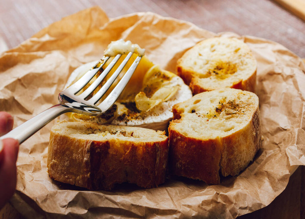 DIY gebackenen Käse Camembert Anleitung Schritt für Schritt. Schritt 5 Camembert-Verkostung. Schmelzkäse streckt sich. Käse mit weißem Schimmelpilz - Foto, Bild