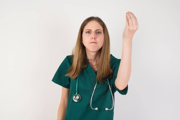 młody piękny pielęgniarka robi włoski gest z ręki i palców pewny wyraz twarzy - Zdjęcie, obraz