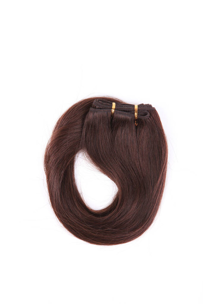 Підроблене коричневе волосся на стрічці на білому ізольованому фоні
 - Фото, зображення