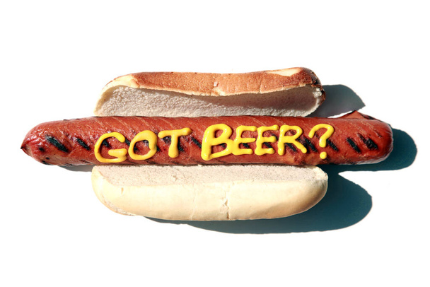 Hot Dog. Hot Dog with mustard. Isolated on white. Room for text. Hot Dog in a bun. The words HOT DOG are easily replaced with your own. Hot Dog in bun with words in yellow mustard.  Its a Hot Dog or Sausage Party! word game in mustard on hot dog.  - Φωτογραφία, εικόνα