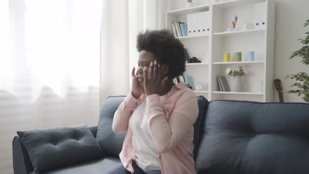 Distressed african woman rubbing temples, having headache, stressful life - Кадри, відео