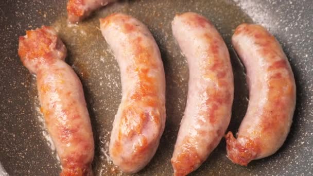 Cooking traditional Bavarian sausages. German pork sausages - Footage, Video