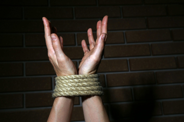 Tied hands on dark background - 写真・画像