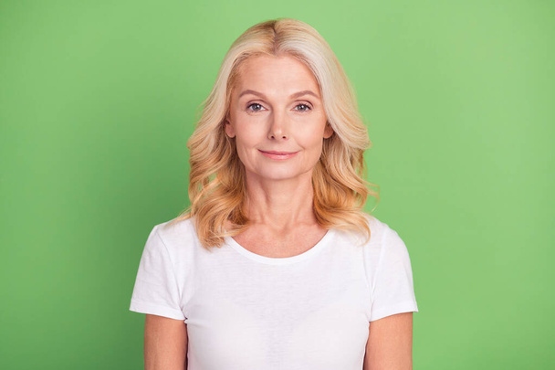 Photo of sweet blond elder lady wear white t-shirt isolated on pastel green color background - Фото, изображение