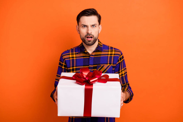 Photo of shocked unsatisfied person hands hold giftbox open mouth staring isolated on orange color background - Foto, imagen
