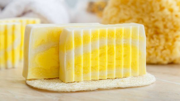 Natural handmade soap bars. Fragrant soap bars for spa treatments with loofah sponge, natural sea scrubber. Toiletries and Bath cosmetic product for hygiene skincare. Zero waste. Long web banner. - Valokuva, kuva