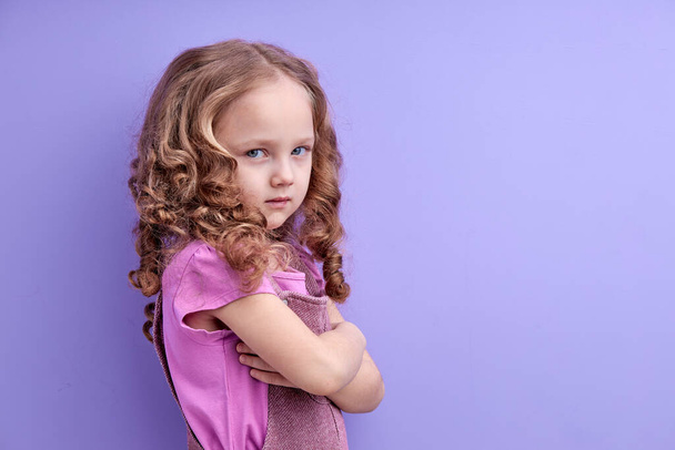 Serious pensive little kid girl looking unhappy at camera, tired upset preschool child - 写真・画像