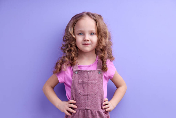 Positive Smiling Child Girl Isolated On Purple Background, Look At Camera - Φωτογραφία, εικόνα