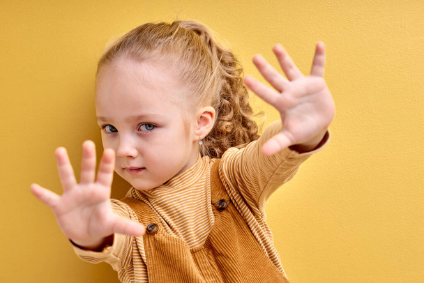 beautiful caucasian little girl afraid and terrified with fear expression stop gesture - Foto, Imagem
