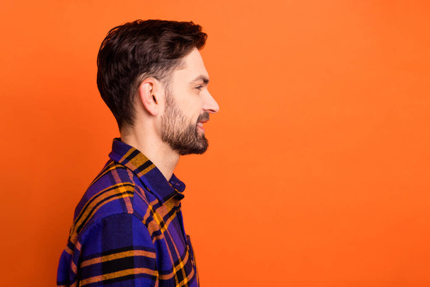 Profile side photo of young cheerful guy happy positive smile look empty space isolated over orange color background - Фото, зображення