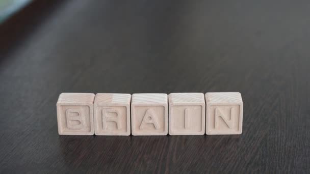 Female hands change first letter in word brain so that it turns to train - Materiaali, video