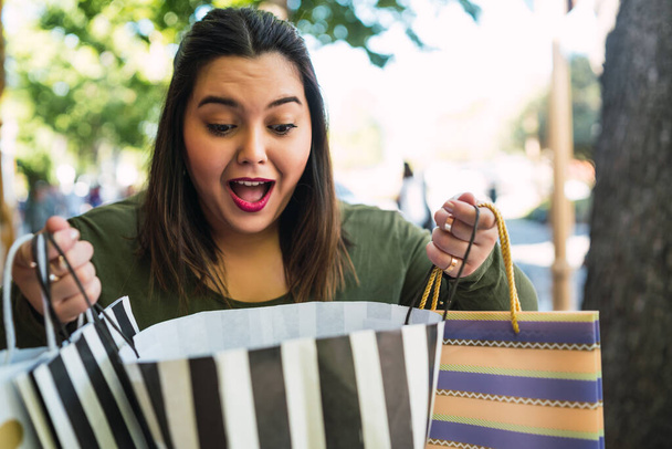 Young woman holding shopping bags. - Zdjęcie, obraz