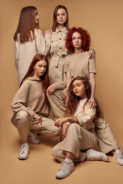 Caucasian redhead young models in fashion week outfits posing together isolated - Фото, изображение